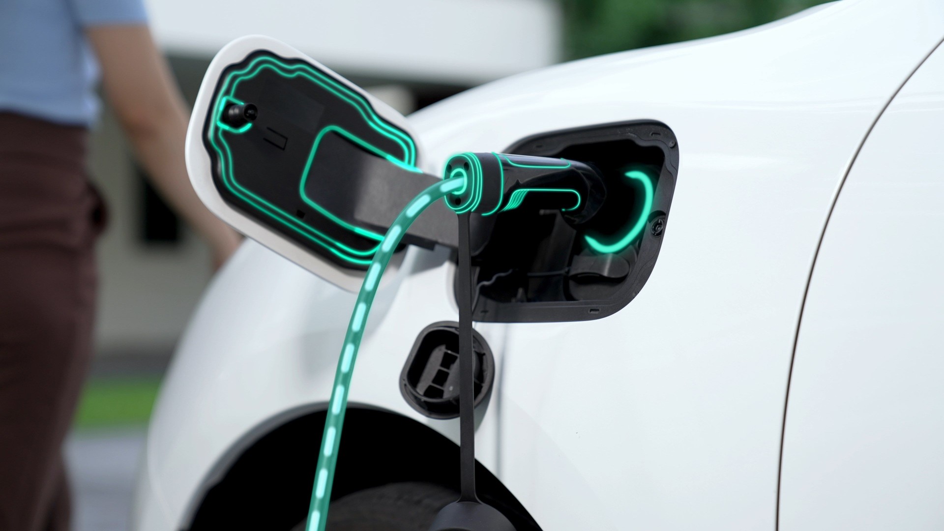 EV charger from home charging station plugged in EV car. Peruse